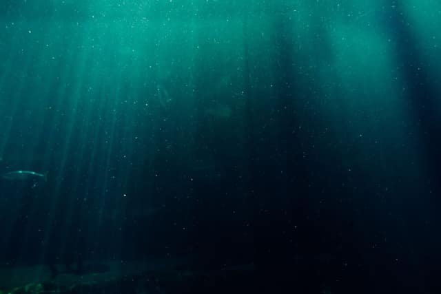 Sunlight filtering through dark blue-green ocean water